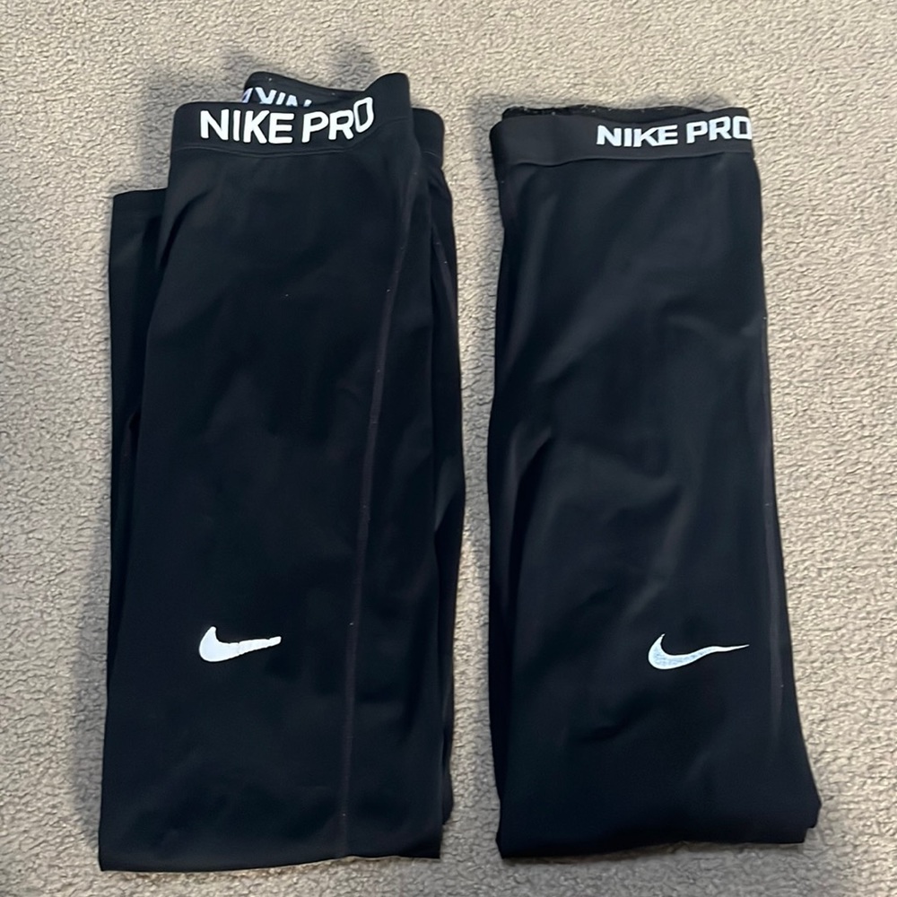 TWO pairs of black Nike Pros